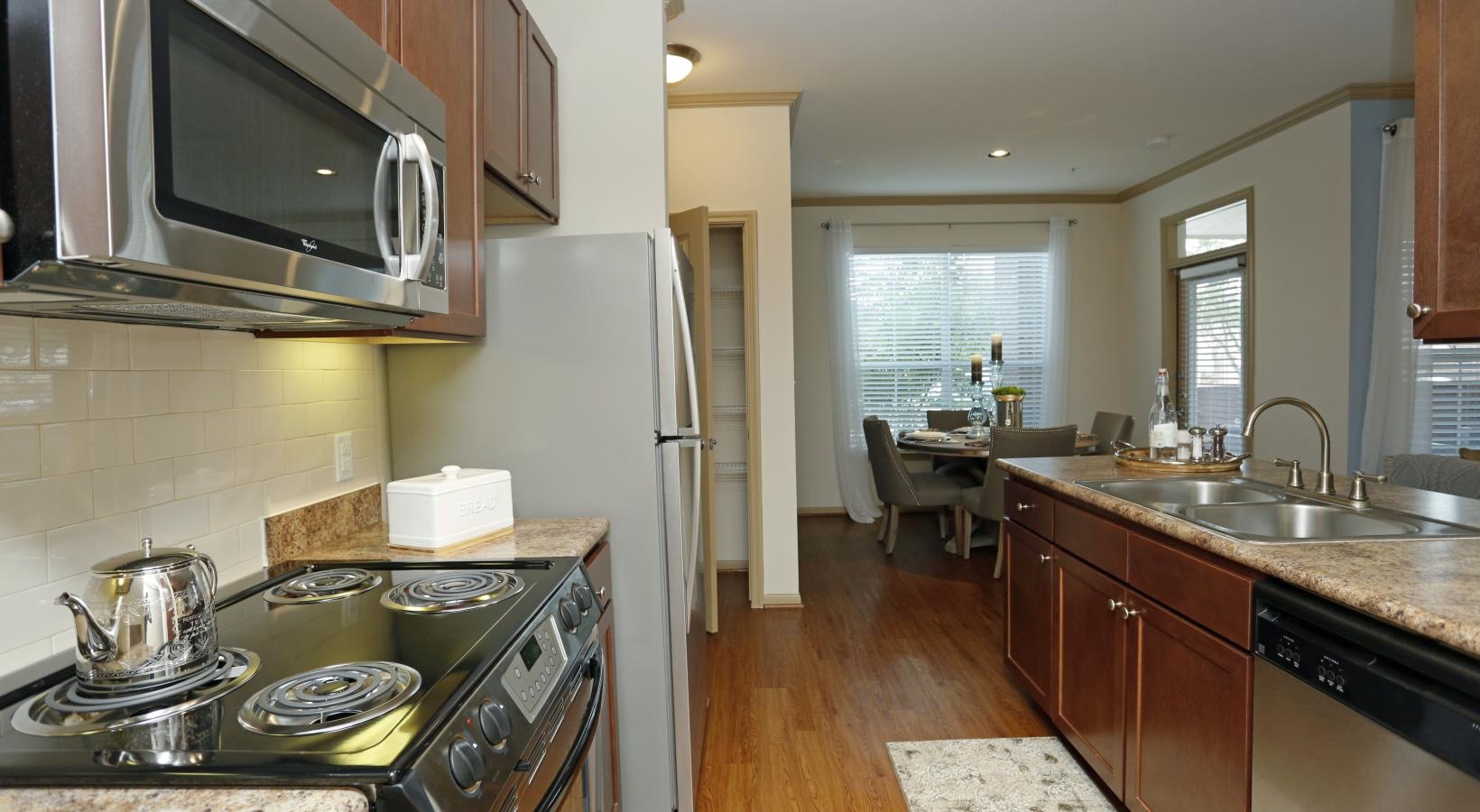 Spacious kitchens with thoughtful details a kitchen with stainless steel appliances