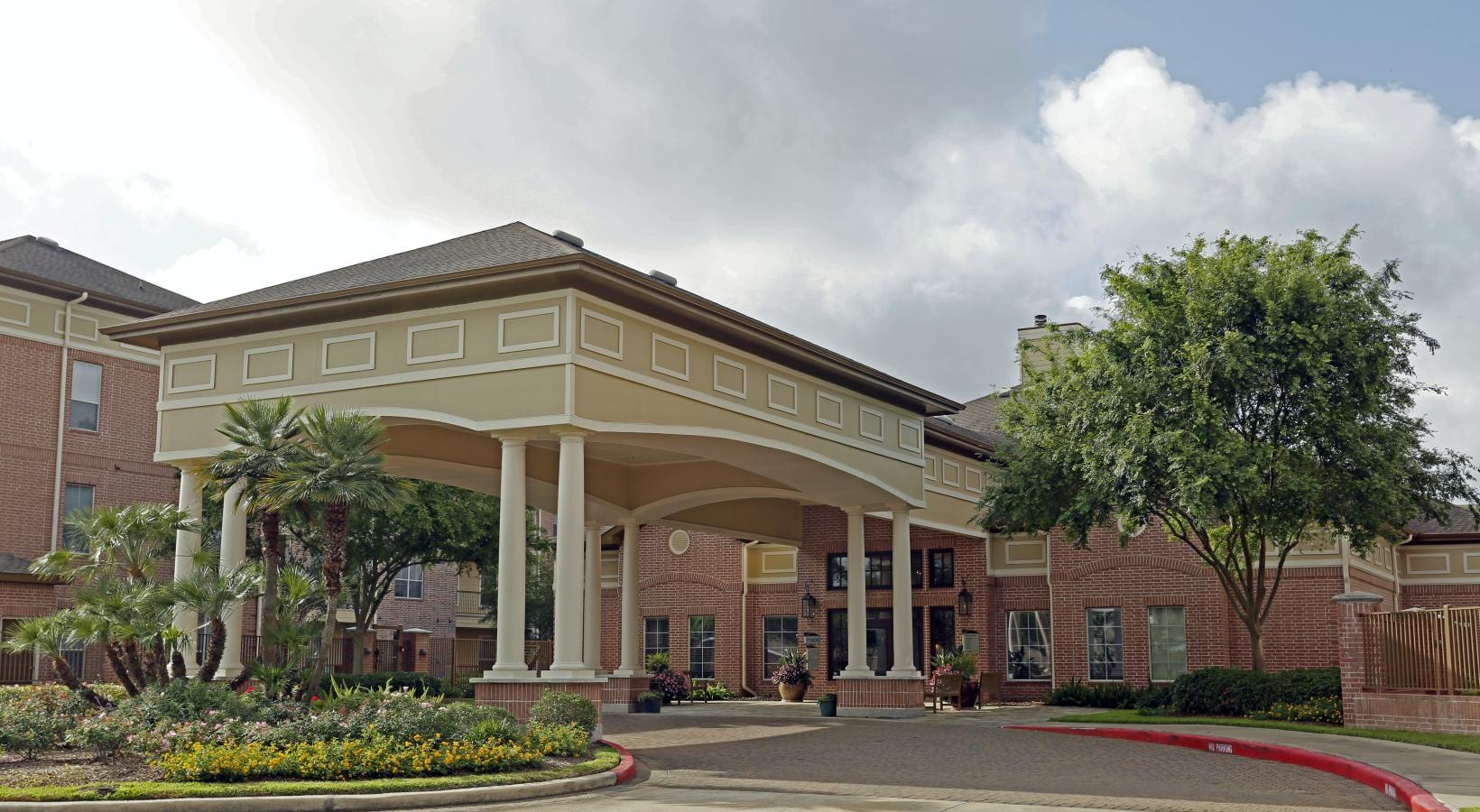 Find your perfect fit at Elate Royal Oaks front of a building with pillars and a parking lot