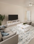 a living room with a white table and a white couch