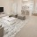 a living room with a white table and a white couch and tv