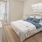 a bedroom with a bed and a fan and window