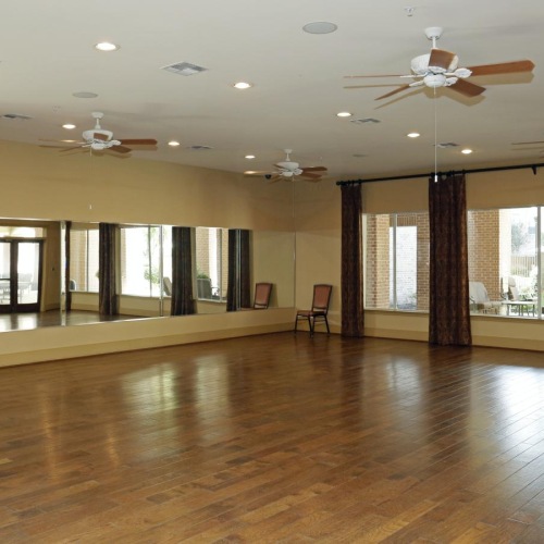 Take advantage of all Elate Royal Oaks has to offer a large room with a wood floor and a wall of mirrors and windows