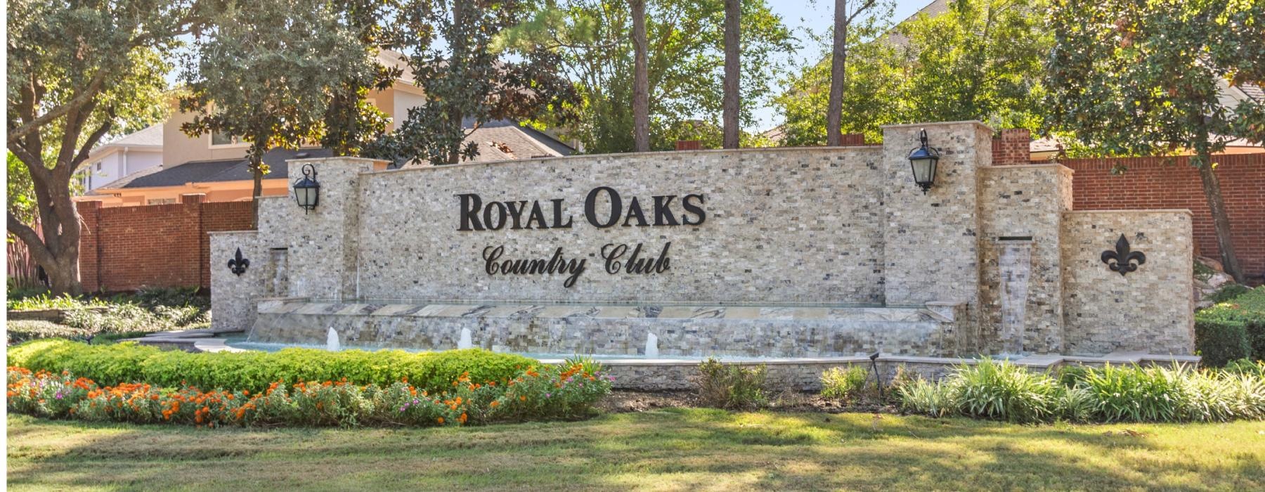 Find your perfect fit at Elate Royal Oaks a stone wall with a sign on it that reads royal oaks