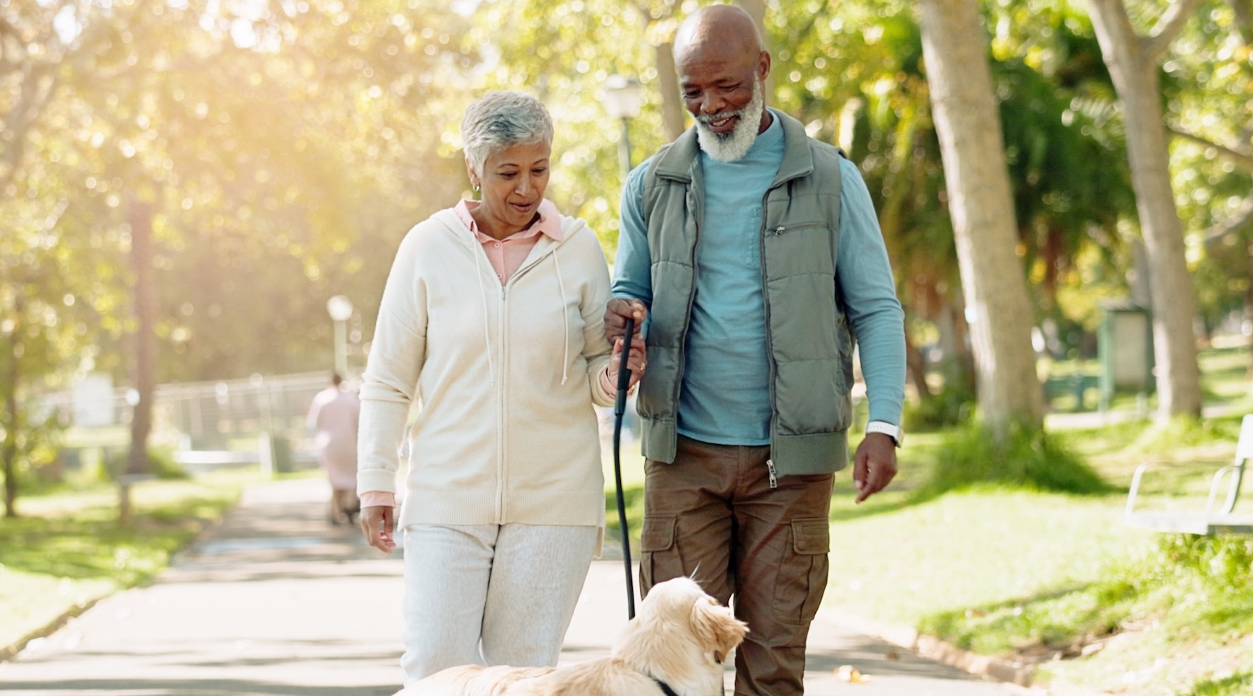 We welcome your pet family a man and woman walking a dog
