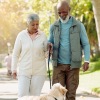 a man and woman walking a dog