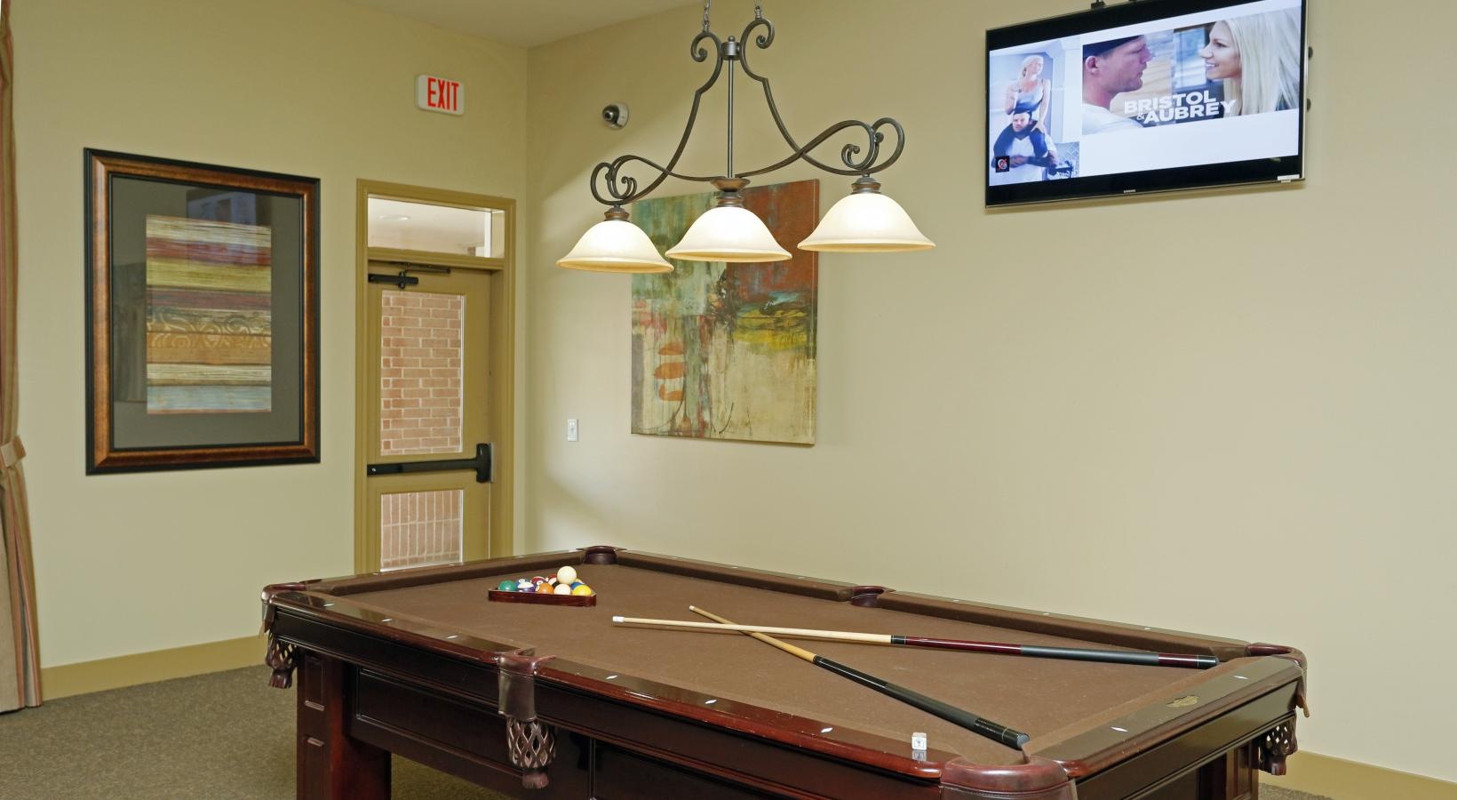 Access to resident-only features a room with a television and a pool table