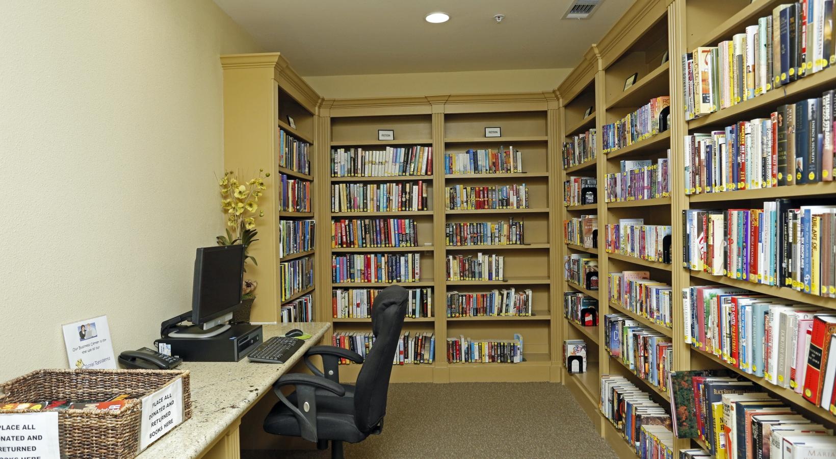 Everything within reach a room with a desk a computer and full bookshelves