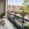 a balcony with a railing and trees