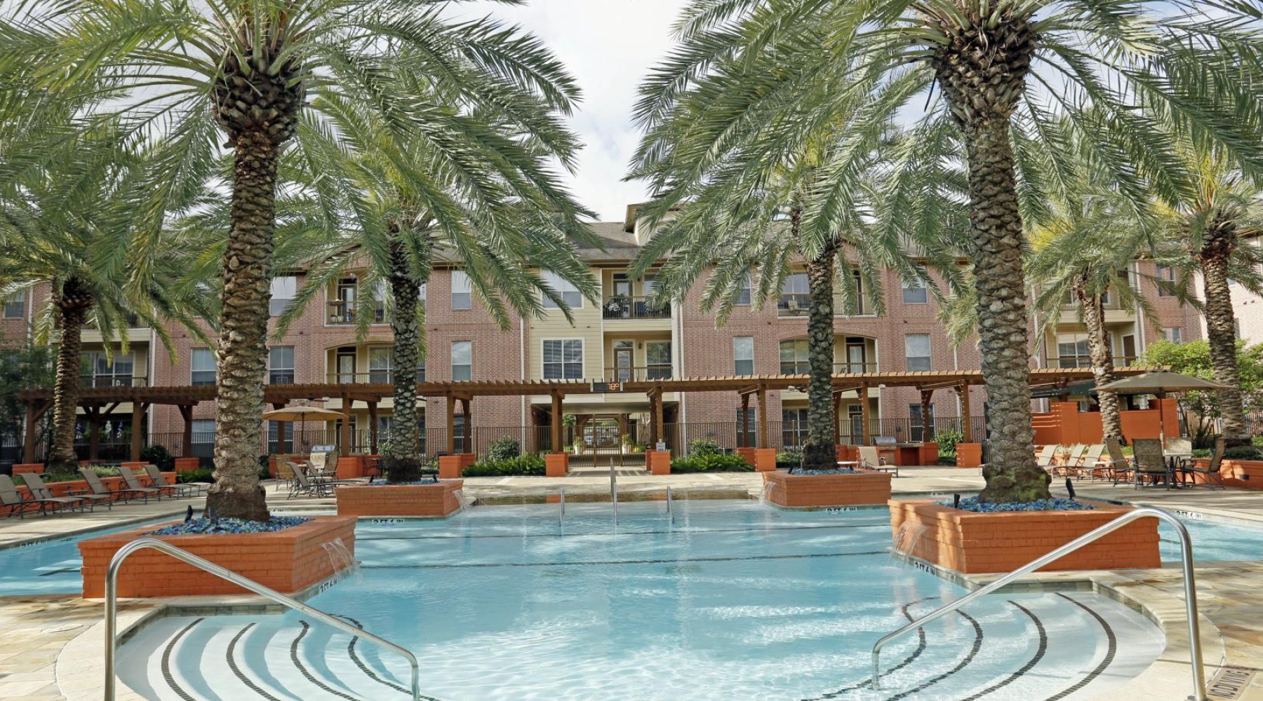 Sparkling swimming pool a swimming pool in front of a building with palm trees